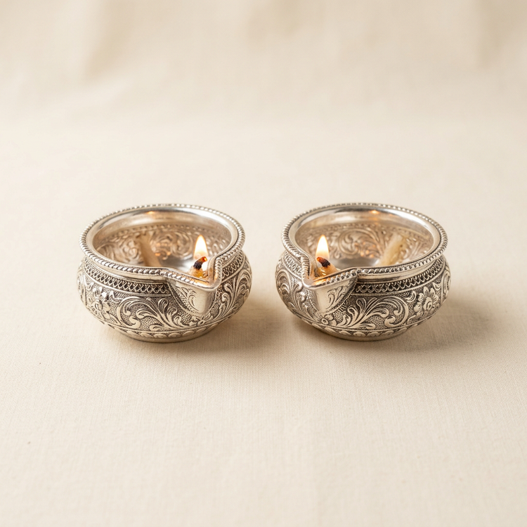 Pair of small silver diyas