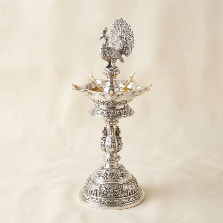 Silver kuthu vilakku standing oil lamp with peacock top